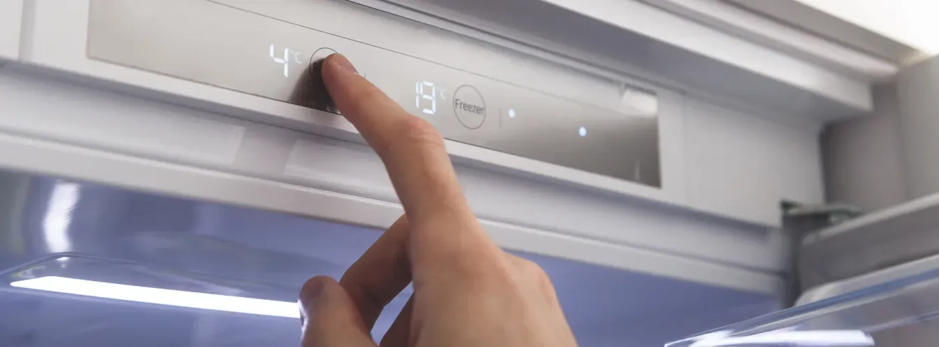 hand-adjusting-refrigerator-digital-temperature